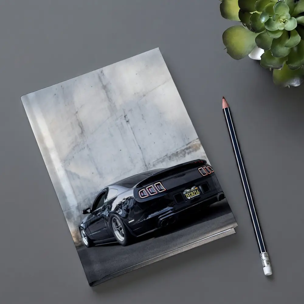 Black Ford Mustang Against Concrete Wall – Notebooks