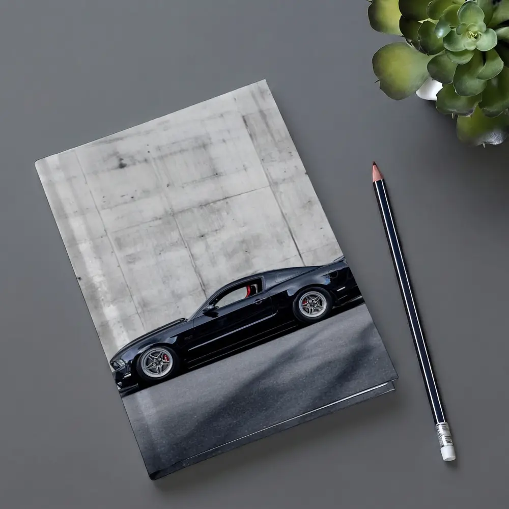 Black Ford Mustang Against Concrete Wall – Notebooks
