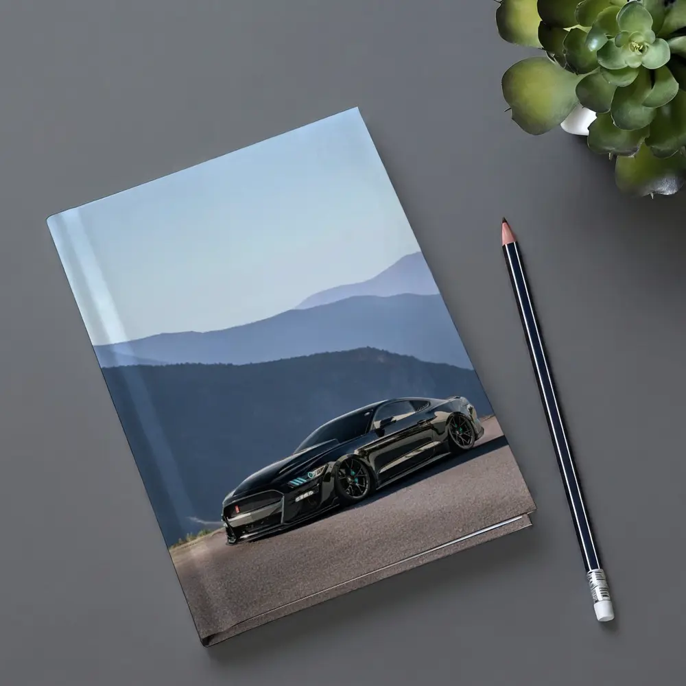 Black Ford Mustang Parked Against Mountain Backdrop – Notebooks