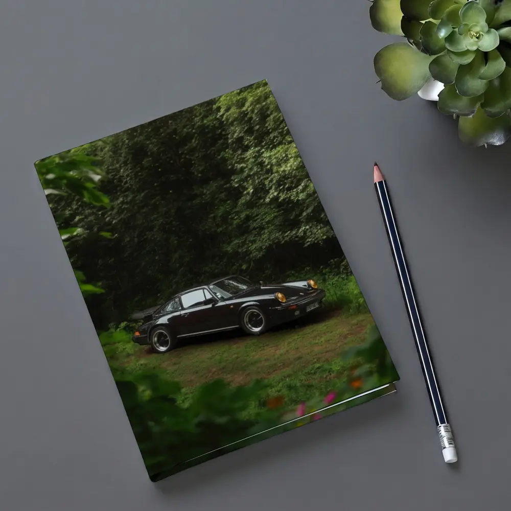 Black Porsche 911 Parked in Green Forest – Notebooks