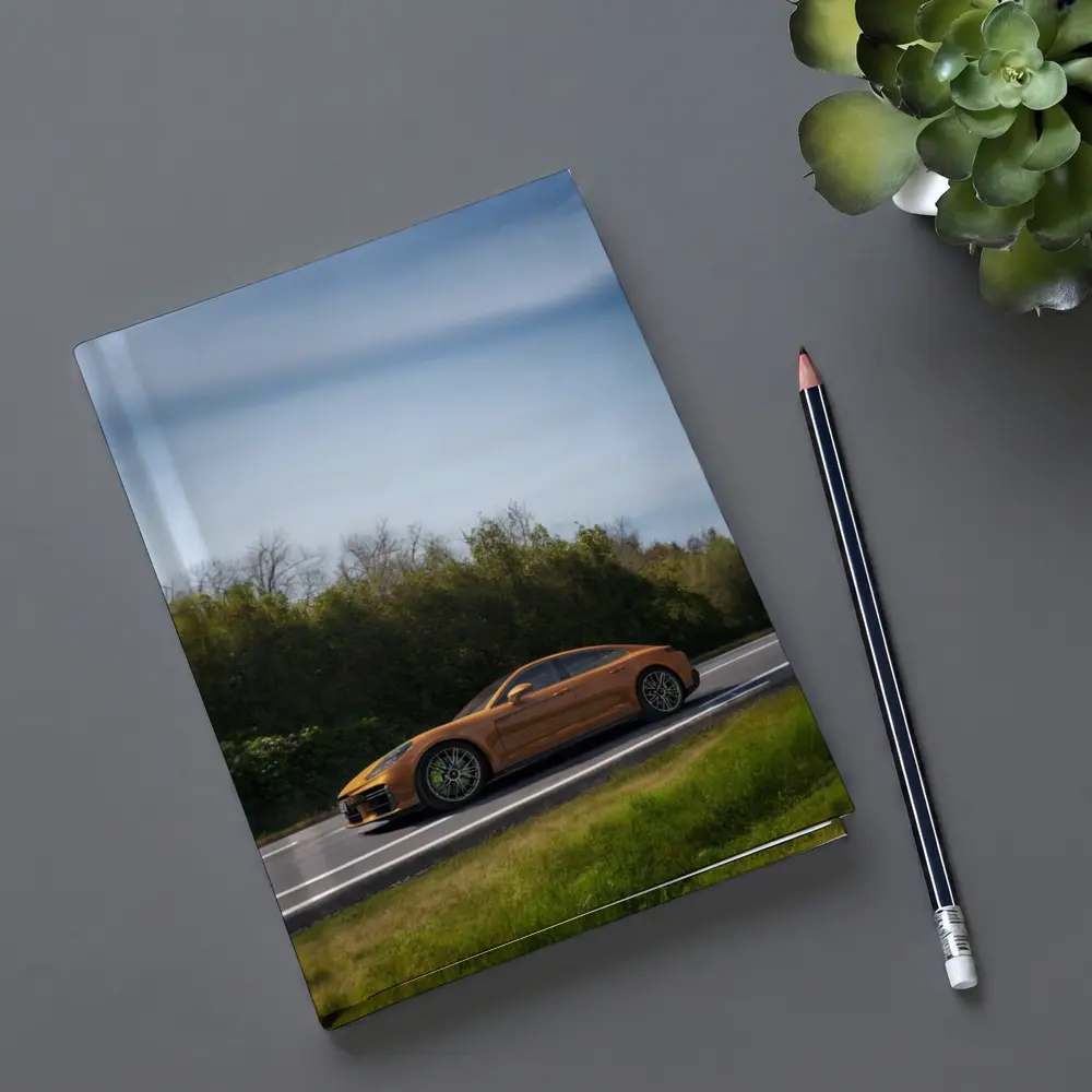 Porsche Panamera Orange on Open Road – Notebooks
