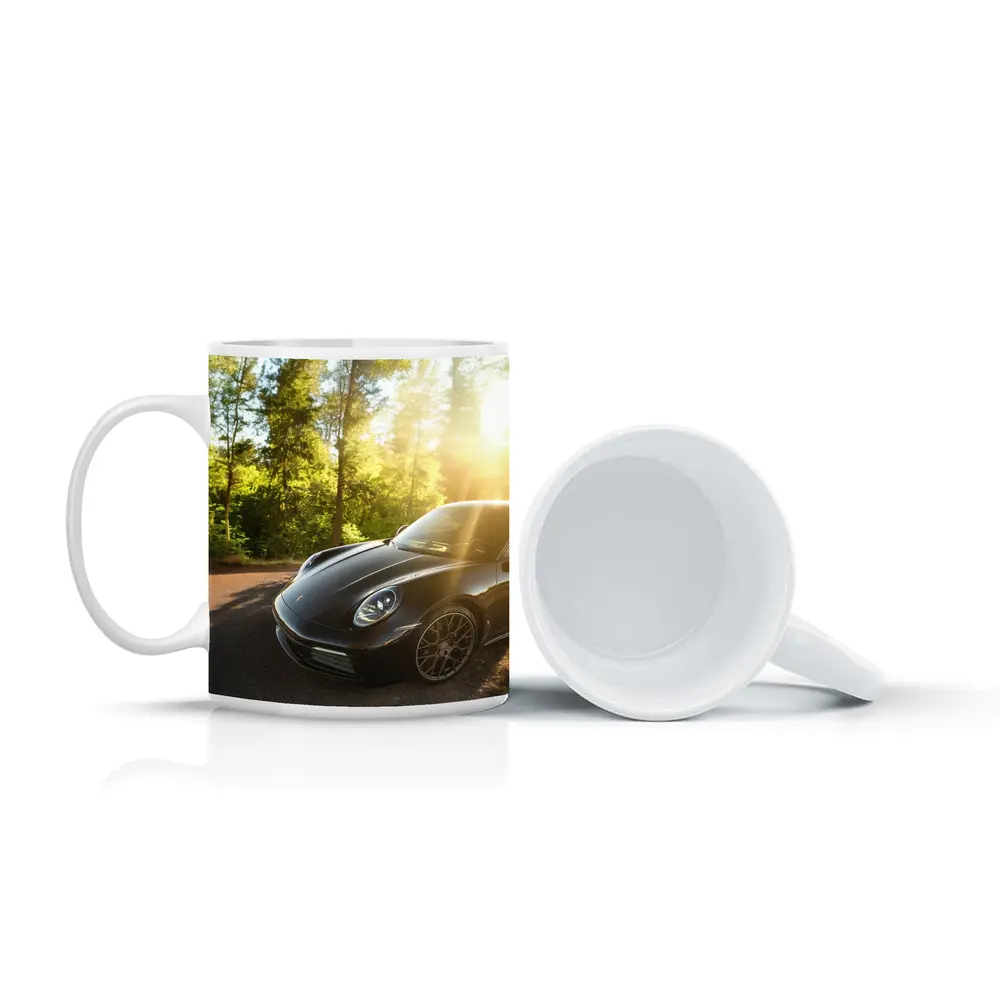 Black Porsche 911 Parked in Sunlit Forest – Mugs