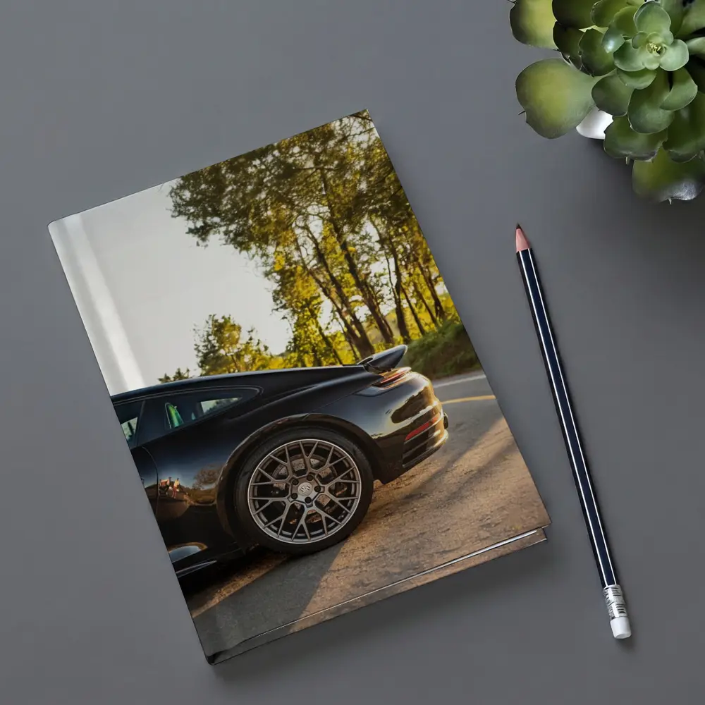 Black Porsche 911 On Scenic Forest Road – Notebooks