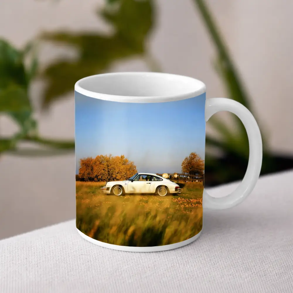 White Porsche 911 Parked in Autumn Field – Mugs