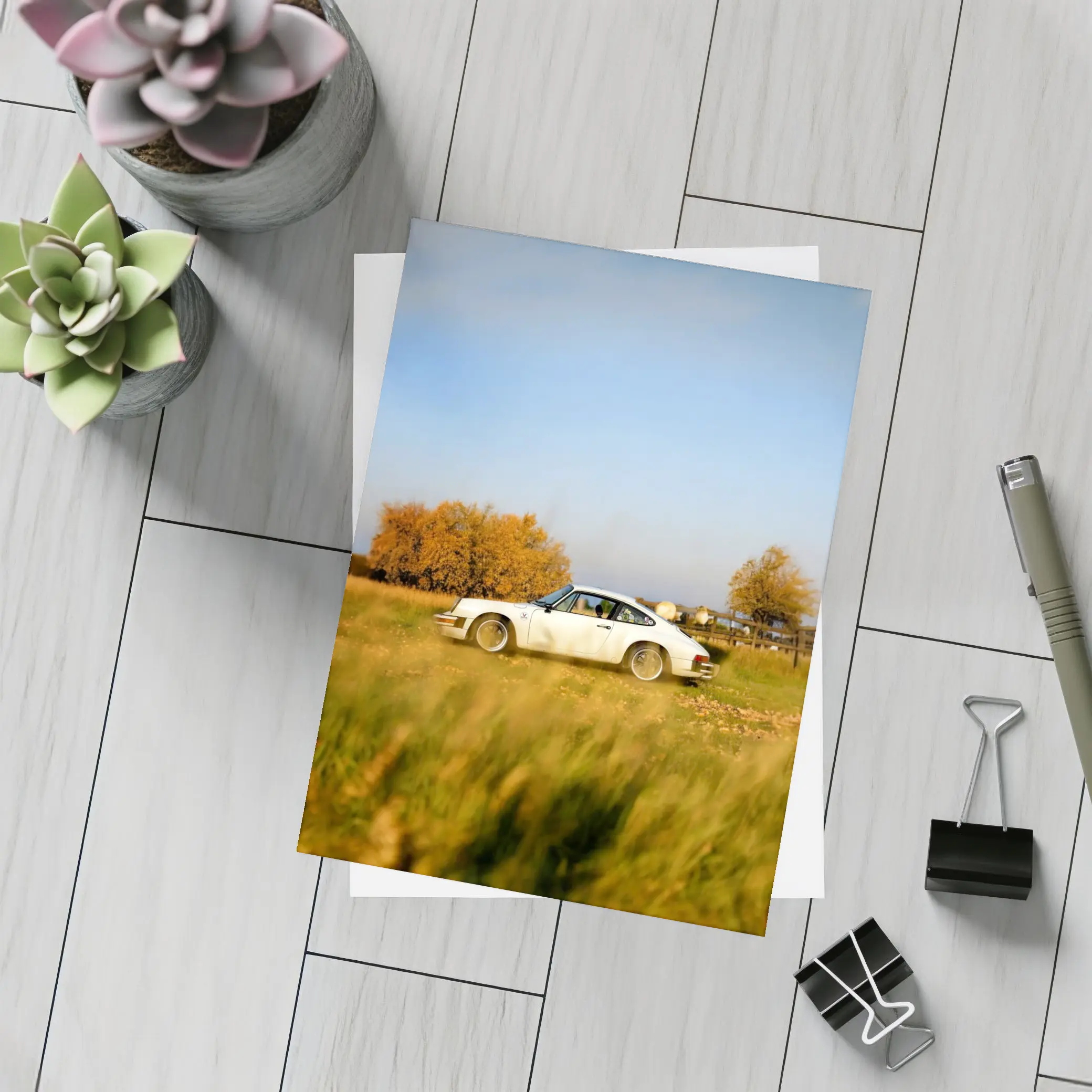 White Porsche 911 Parked in Autumn Field – Postcards
