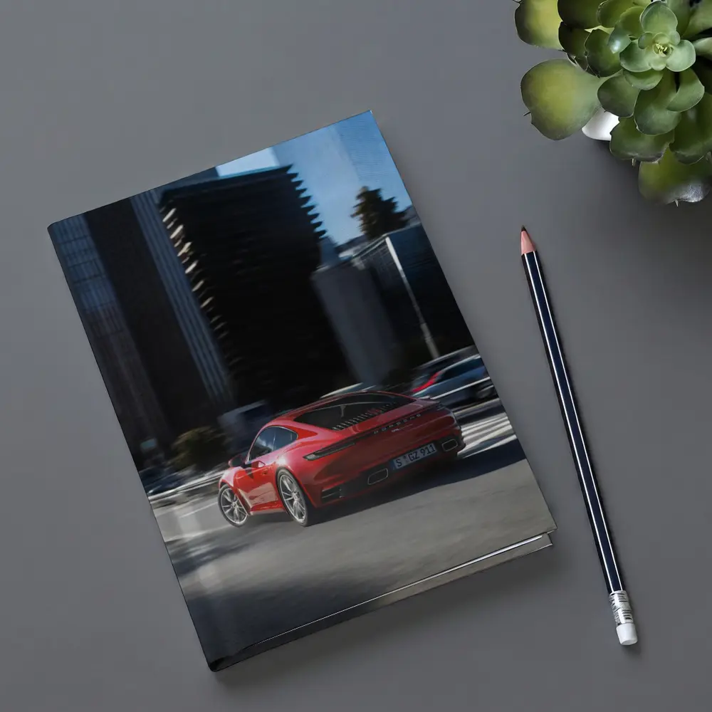 Red Porsche 911 Driving Through City Streets – Notebooks