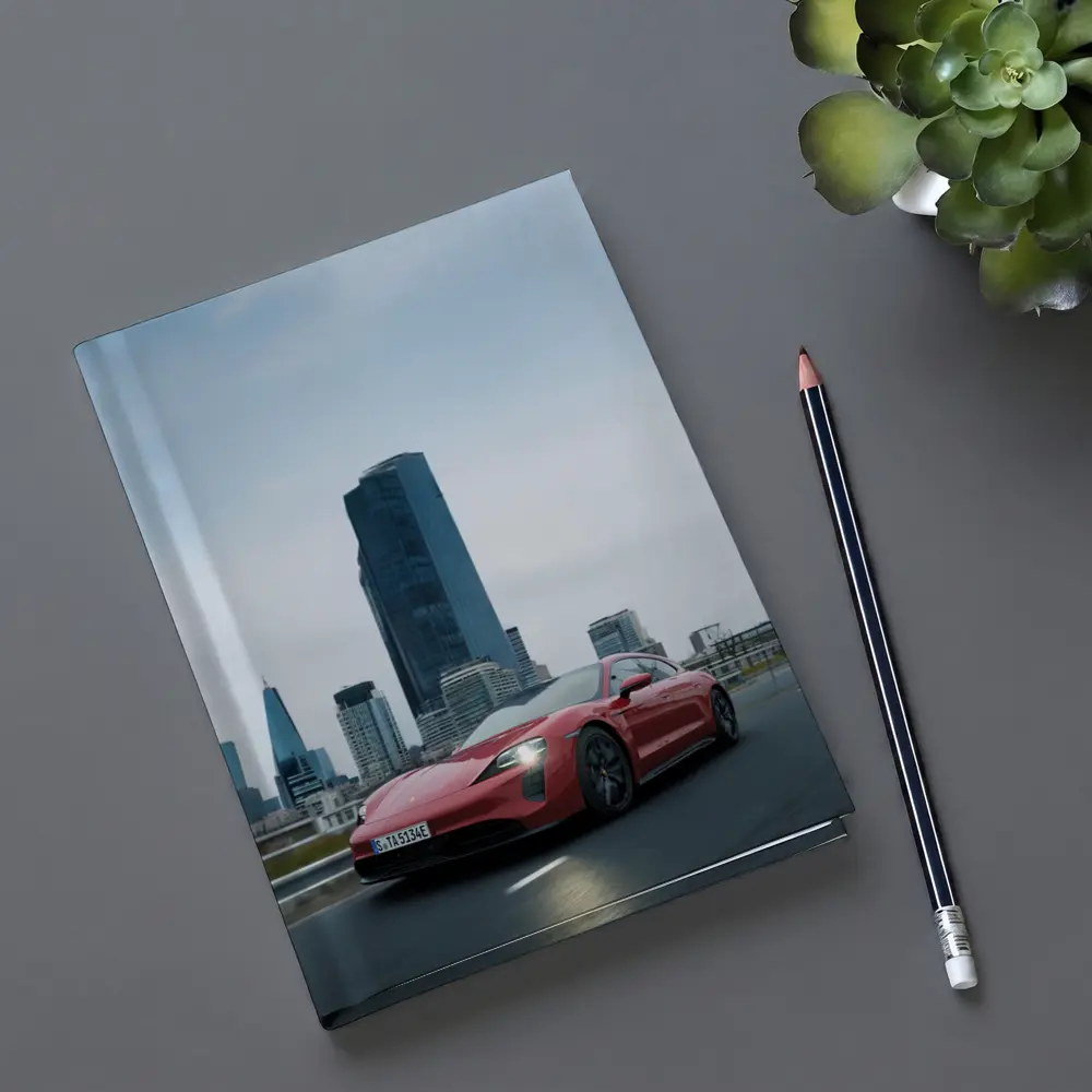 Red Porsche Taycan Driving Through City Skyline – Notebooks