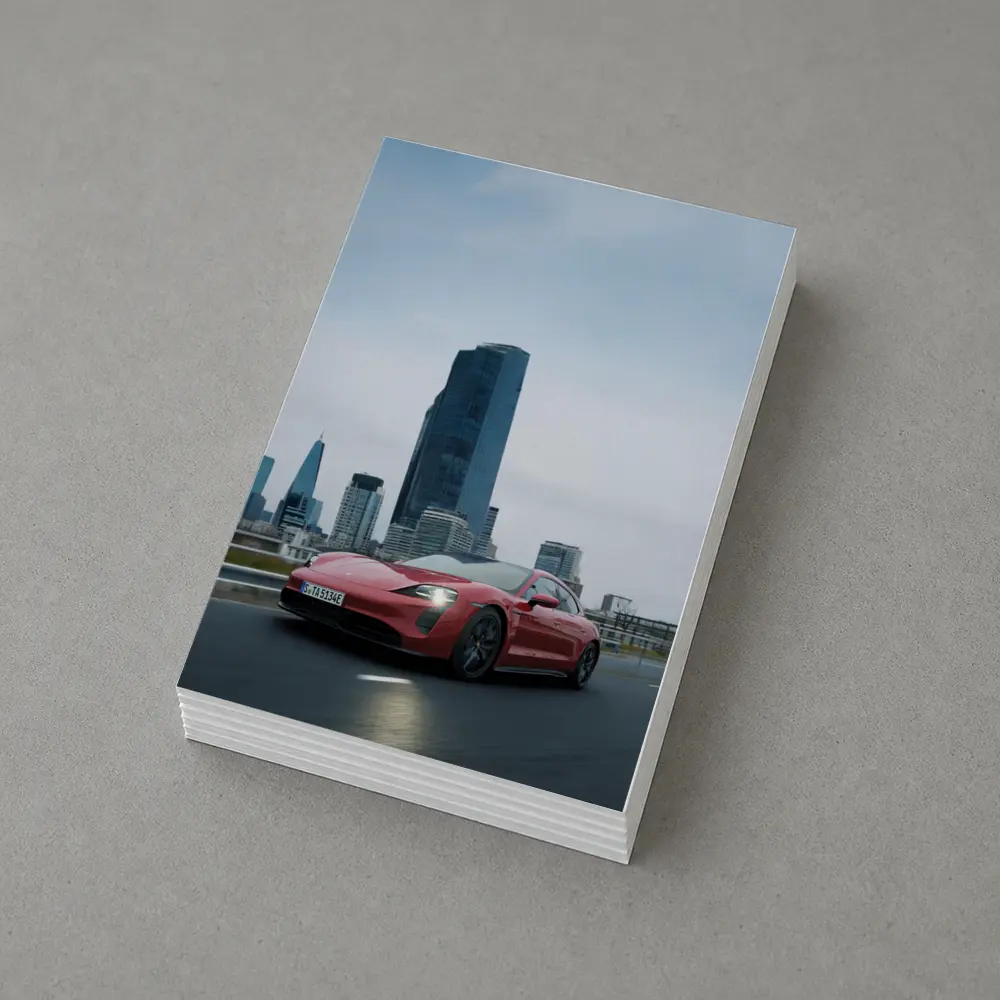 Red Porsche Taycan Driving Through City Skyline – Postcards
