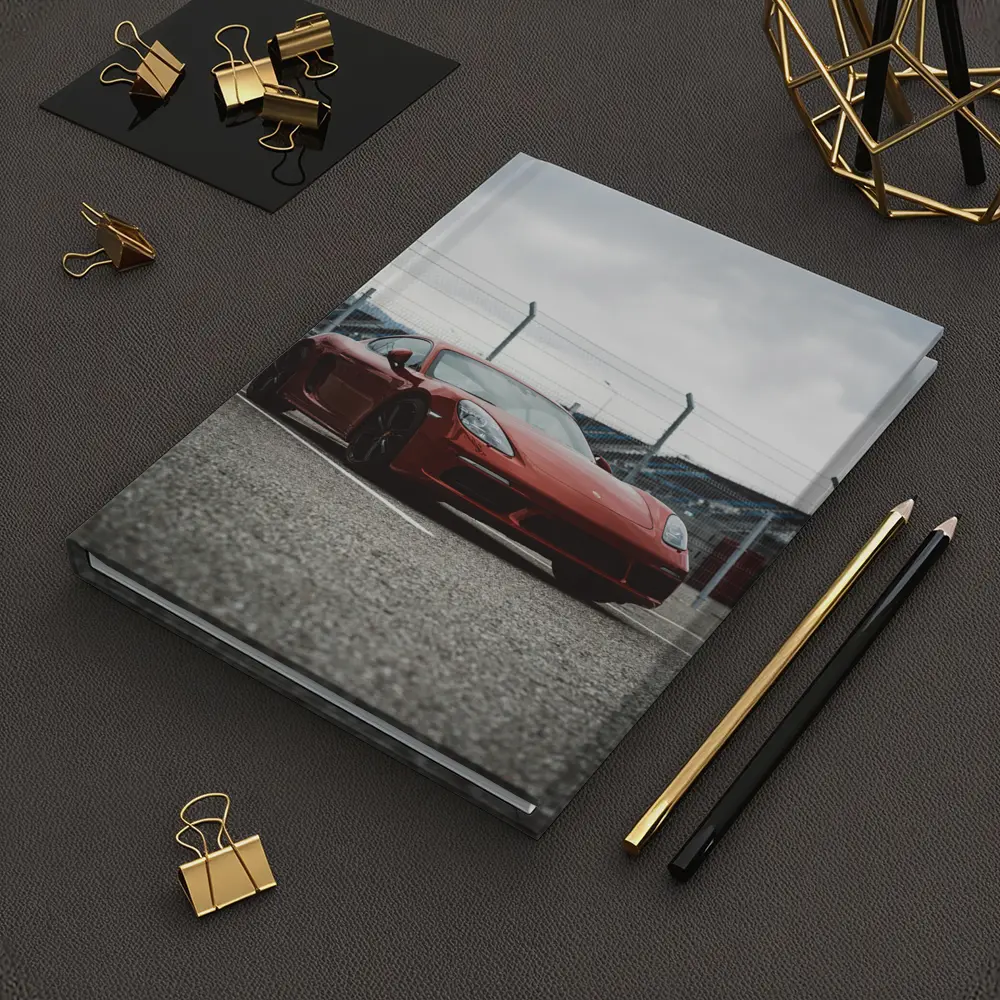 Red Porsche Cayman at Racing Circuit Track – Notebooks