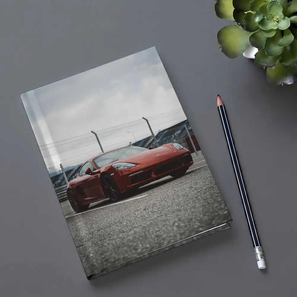 Red Porsche Cayman at Racing Circuit Track – Notebooks