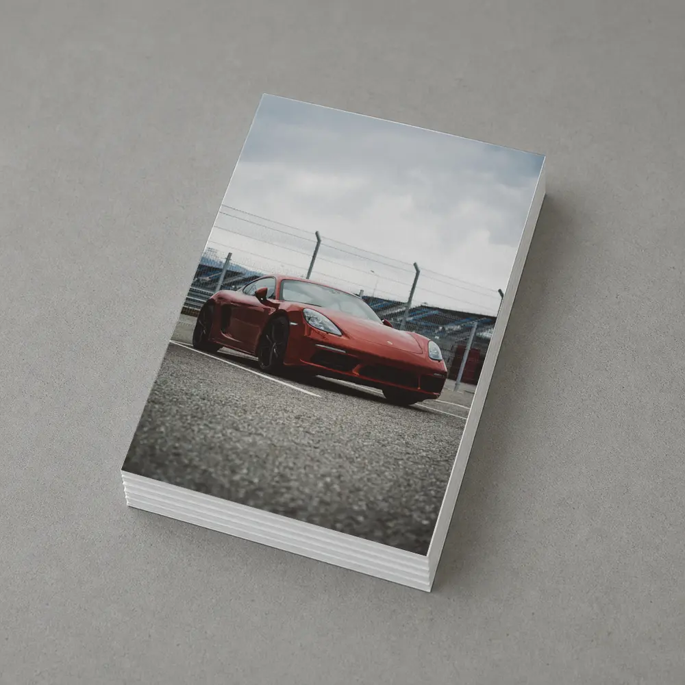 Red Porsche Cayman at Racing Circuit Track – Postcards