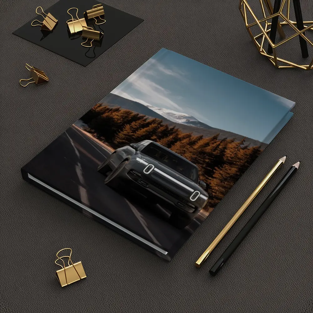 Rivian R1S on Mountain Road Forest Background – Notebooks