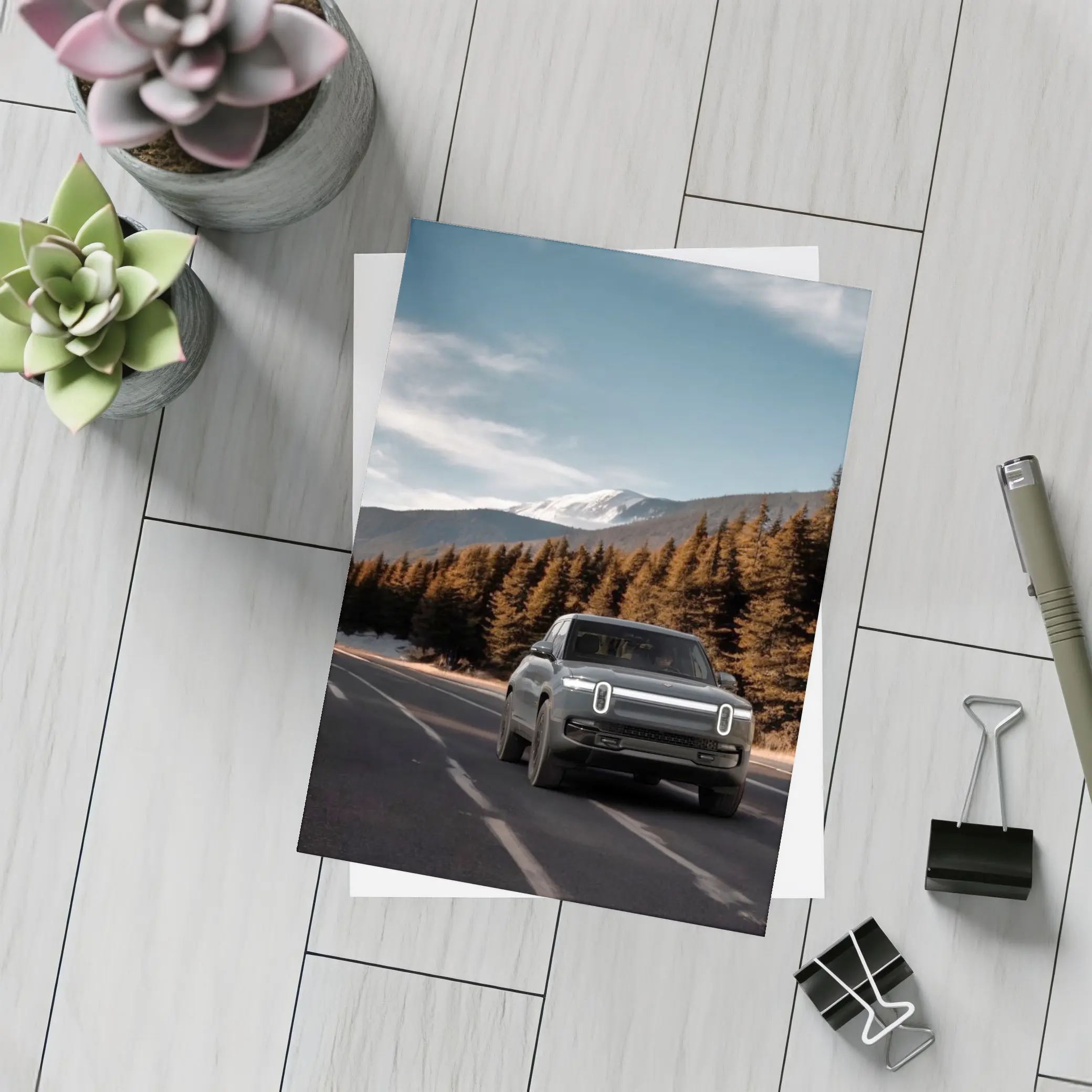 Rivian R1S on Mountain Road Forest Background – Postcards