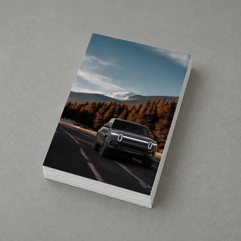 Rivian R1S on Mountain Road Forest Background – Postcards