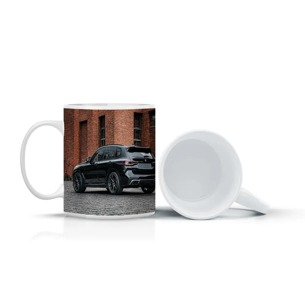 Black BMW X5M Parked Near Brick Building – Mugs