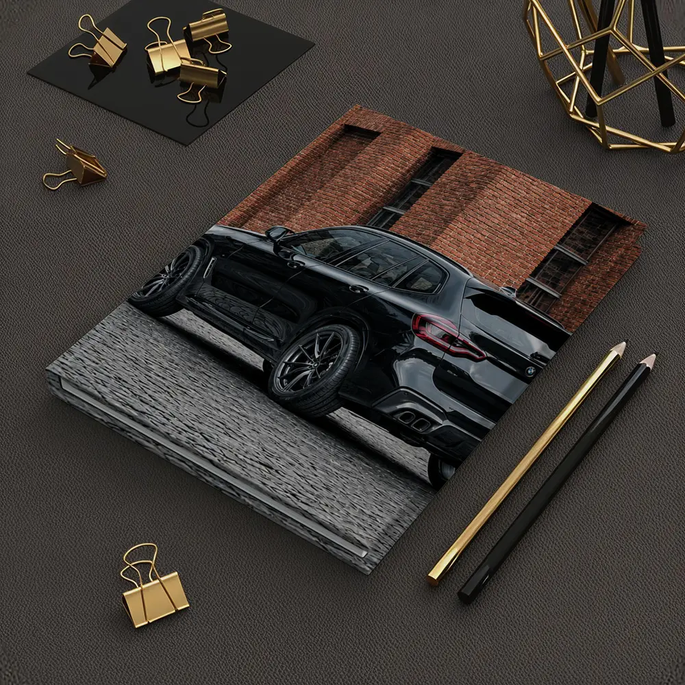 Black BMW X5M Parked Near Brick Building – Notebooks