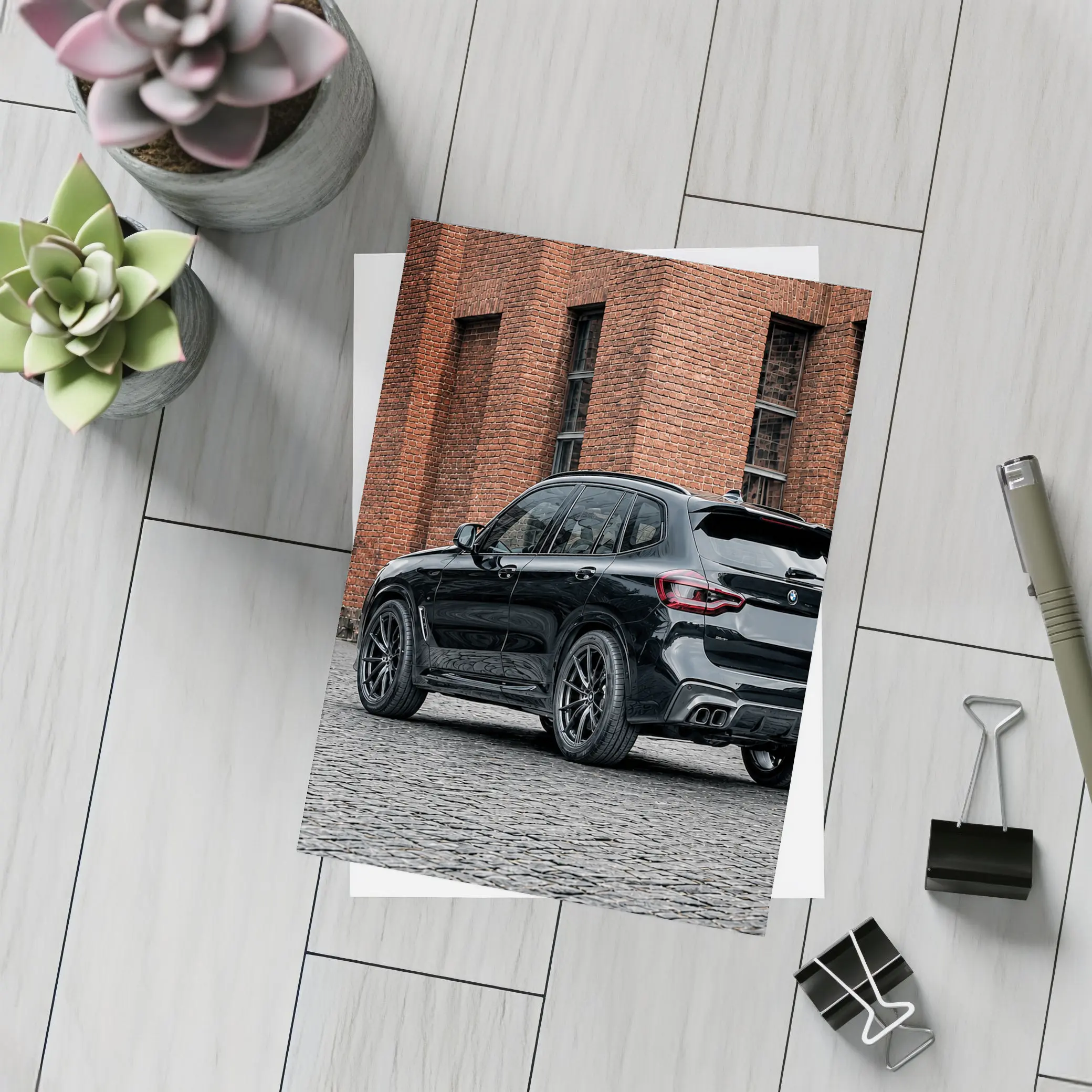 Black BMW X5M Parked Near Brick Building – Postcards