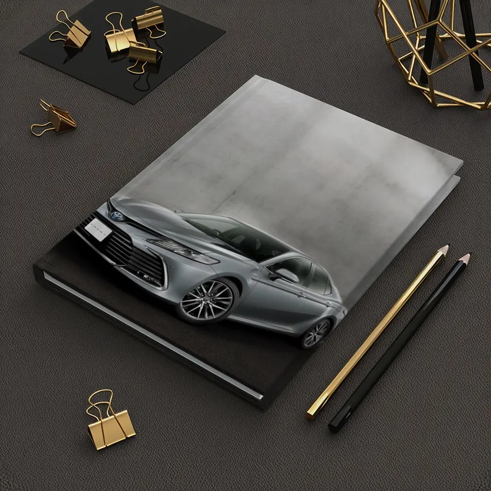 Toyota Camry Silver Sedan Against Gray Wall – Notebooks