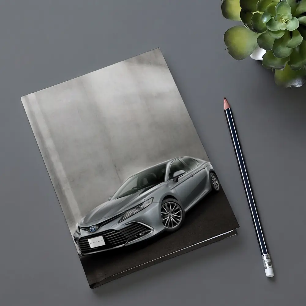 Toyota Camry Silver Sedan Against Gray Wall – Notebooks