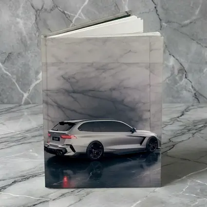 BMW M5 Touring Silver Against Marble Wall