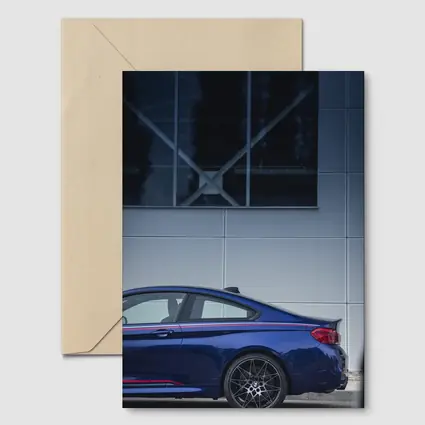 BMW M4 Blue Coupe Against Modern Building