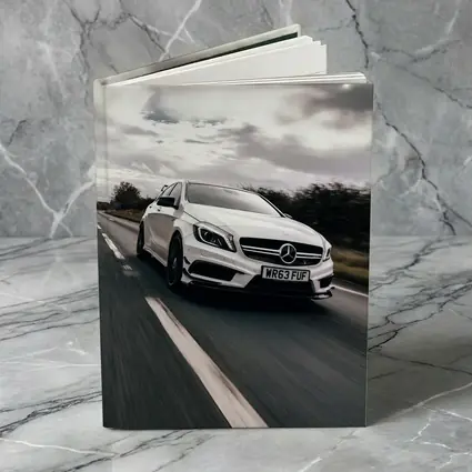 Mercedes AMG White Hatchback On Open Road
