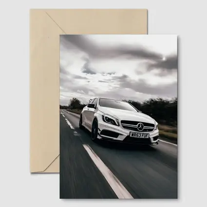 Mercedes AMG White Hatchback On Open Road