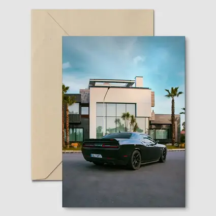Black Dodge Challenger Parked Outside Modern Villa
