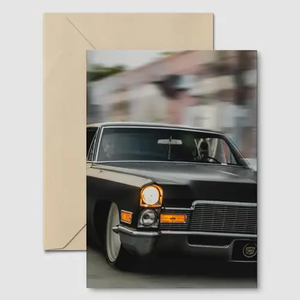 Black Cadillac Lowrider Cruising City Streets