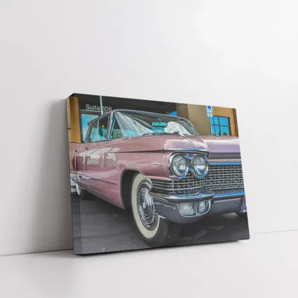 Classic Pink Cadillac Parked Outside Building