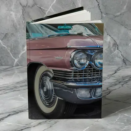 Classic Pink Cadillac Parked Outside Building