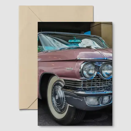 Classic Pink Cadillac Parked Outside Building