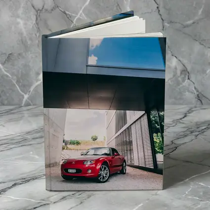 Red Mazda MX5 Parked Under Modern Architecture