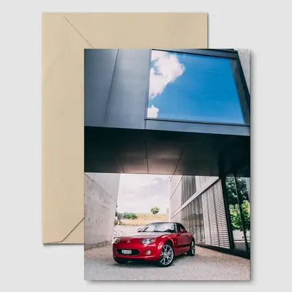 Red Mazda MX5 Parked Under Modern Architecture