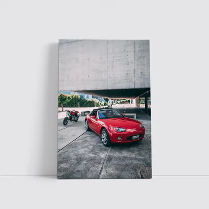 Red Mazda MX-5 Parked Near Concrete Structure