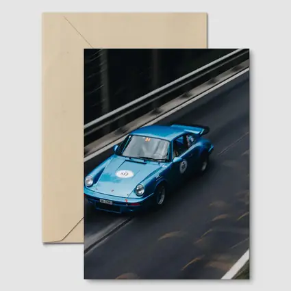 Blue Porsche 911 Racing on Mountain Road