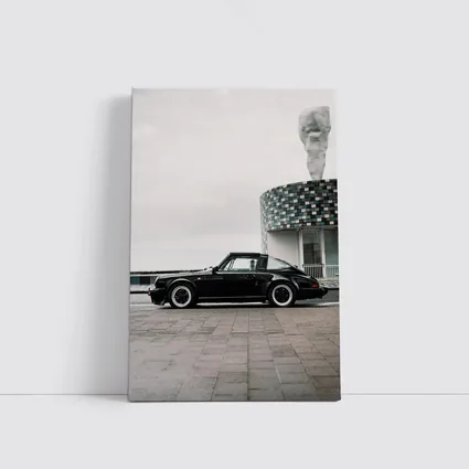 Black Porsche 911 Parked by Coastal Building