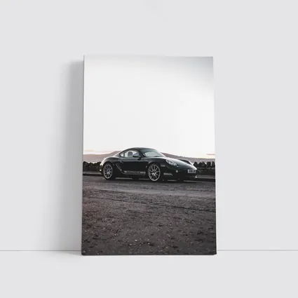 Black Porsche Cayman Parked on Rugged Terrain