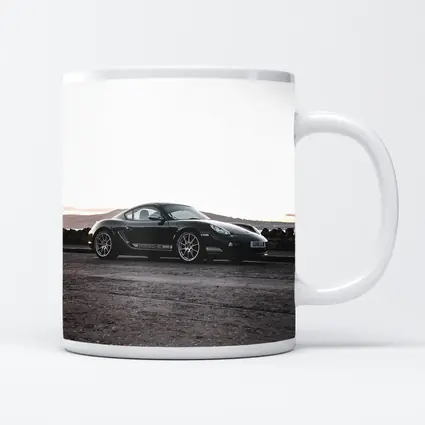 Black Porsche Cayman Parked on Rugged Terrain