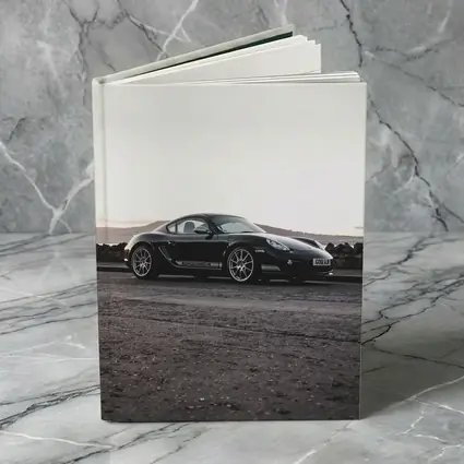 Black Porsche Cayman Parked on Rugged Terrain