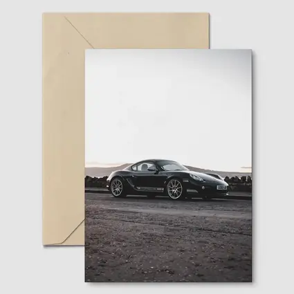 Black Porsche Cayman Parked on Rugged Terrain