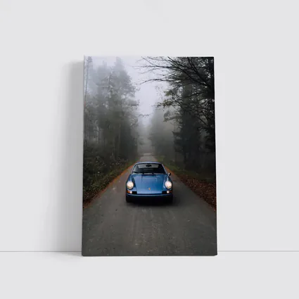 Blue Porsche 911 on Foggy Forest Road