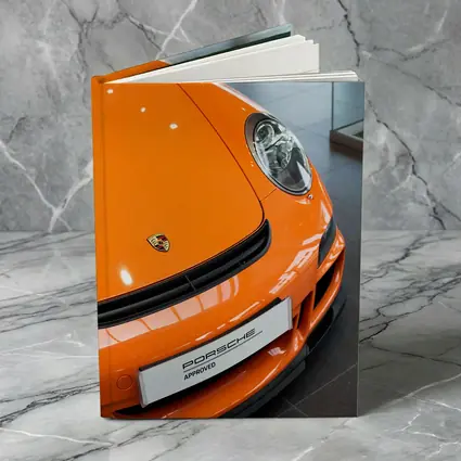 Porsche 911 Orange Front Dealership Interior