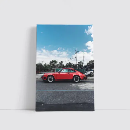 Red Porsche 911 Parked Under Blue Sky