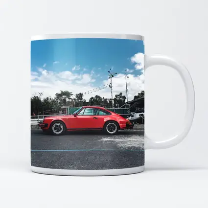 Red Porsche 911 Parked Under Blue Sky