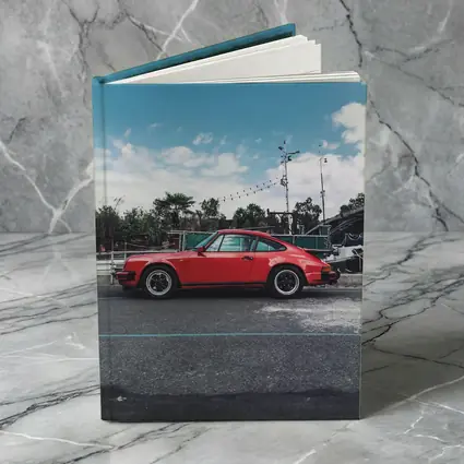 Red Porsche 911 Parked Under Blue Sky