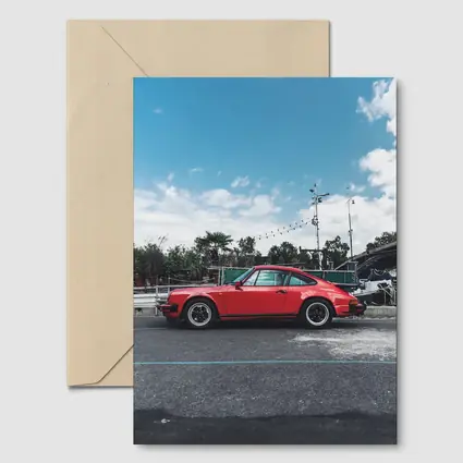 Red Porsche 911 Parked Under Blue Sky