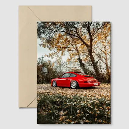 Red Porsche 911 Parked Among Autumn Leaves