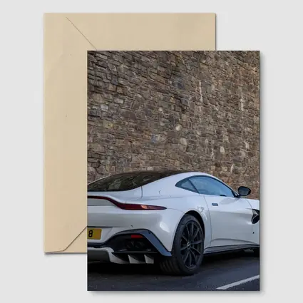 Aston Martin Vantage White Against Stone Wall