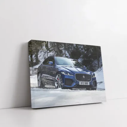 Jaguar XF Blue Sedan Driving Through Snow